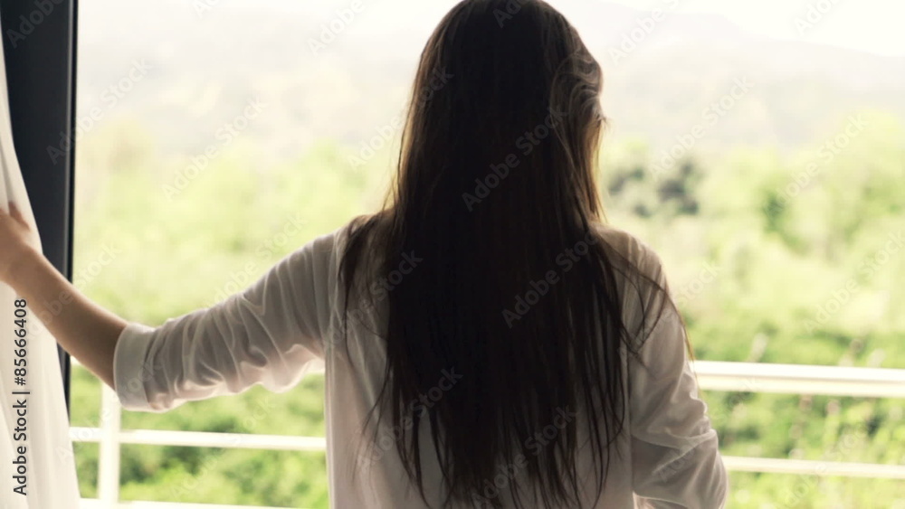 Young woman unveil curtain and walking out on terrace, slow motion shot at 240fps
Young woman unveil curtain and walking out on terrace, slow motion shot at 240fps
