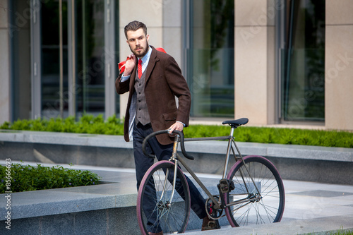 Handsome businessman and his bicycle