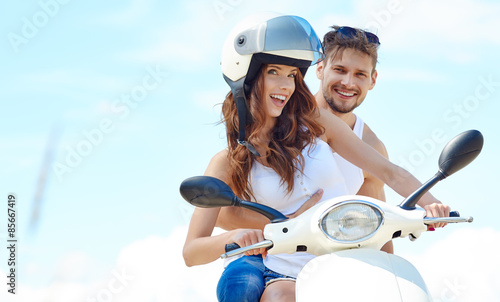 Beautiful young couple in love enjoying and having fun riding on