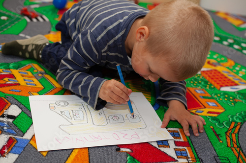 The boy draws pictures.