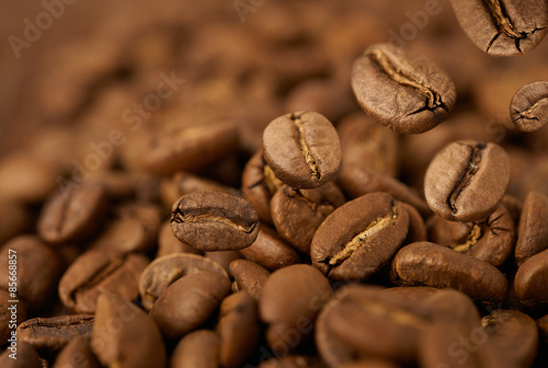 Closeup of coffee beans with focus on one