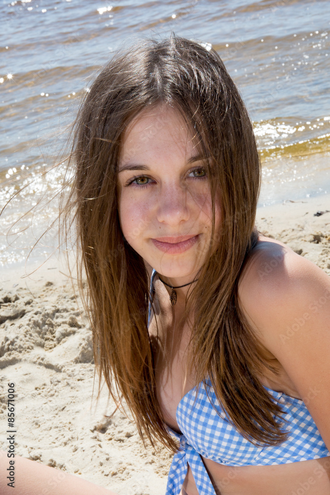 Teenager girl in blue swimming suit on the beach Stock Photo Adobe Stock