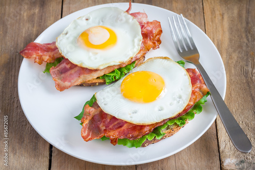 Open face sandwich with egg, bacon, tomato and lettuce