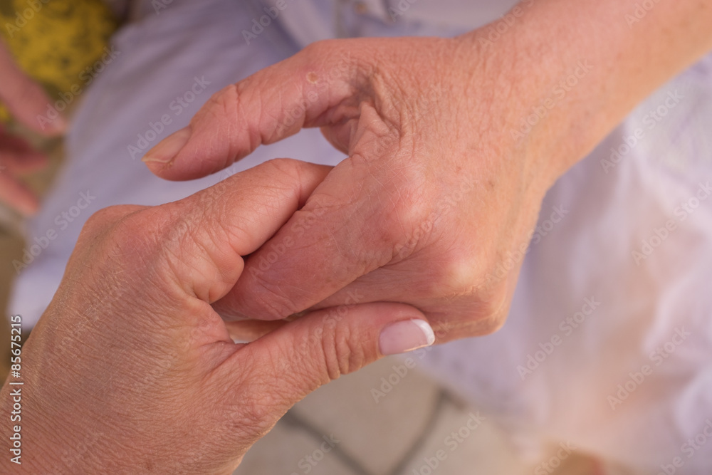 Hands of an elderly woman holding the hand of a younger woman. Hands of an elderly woman holding the hand of a younger woman.