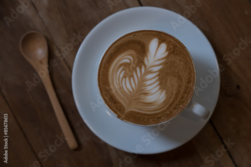 coffee latte art on the wood desk vintage color