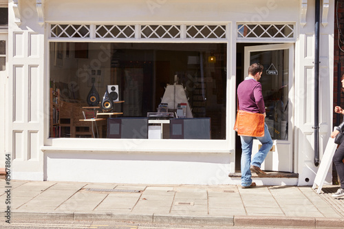 Shop owner opening up record, CD and hi-fi shop