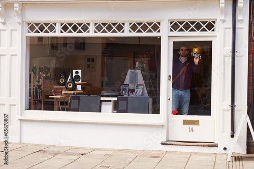Shop owner opening up record, CD and hi-fi shop