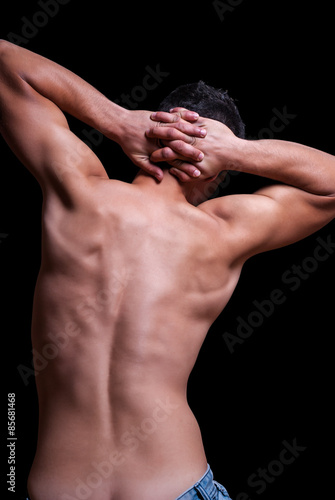 Highlighted back of male posing topless