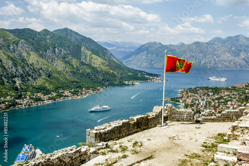 Montenegrin flag flying in the fortress wall in the old town of