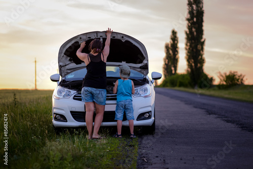 Mother and Son Repairing Something on their Car