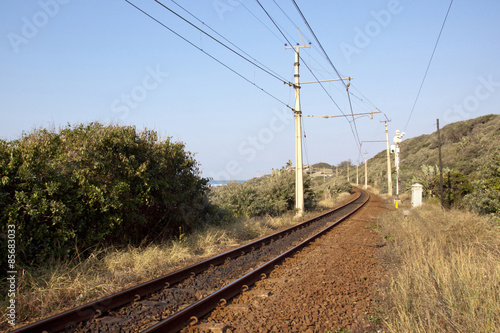 Railway Line Running Between Vegetation Alongside Indian Ocean
