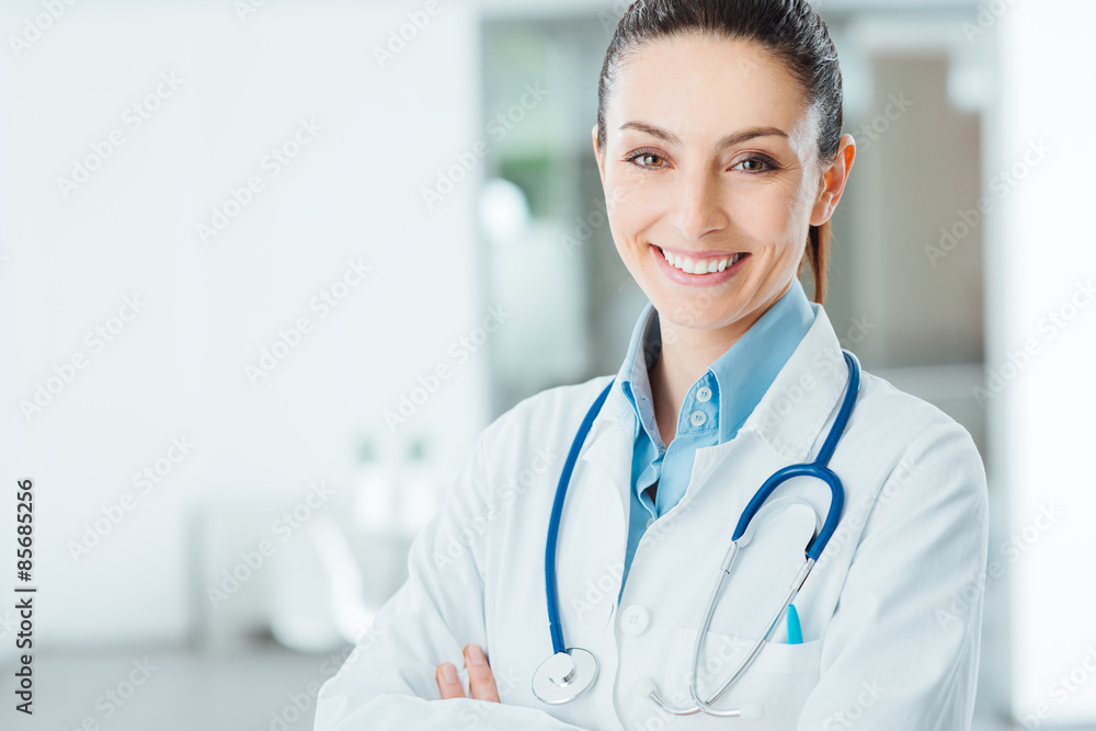 Confident female doctor posing in her office Confident female doctor posing in her office