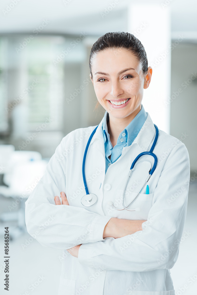 Confident female doctor posing in her office Confident female doctor posing in her office