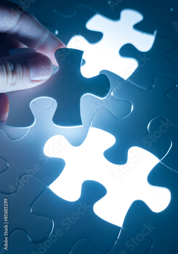 Hand insert jigsaw, conceptual image of business strategy, decis