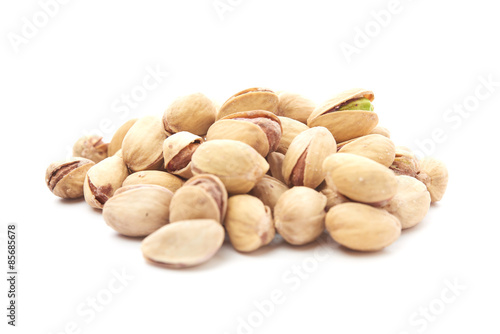 Heap of pistachios nuts isolated on the white