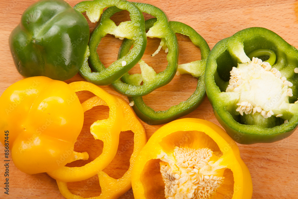 Cut yellow and green bell peppers on cutting board Cut yellow and green bell peppers on cutting board