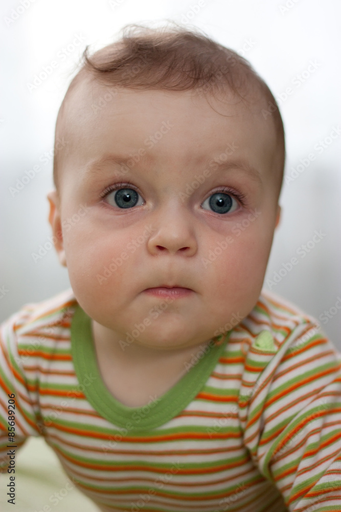 Portrait of a little boy with big eyes close up