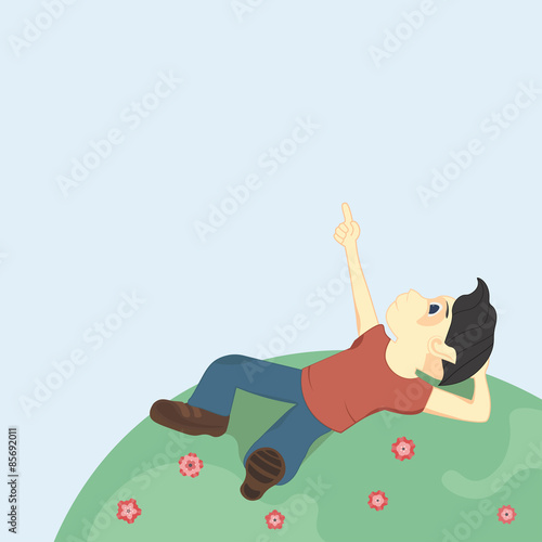 Boy with black hair lying on the ground and looking up at the sky, pointing at something interesting.