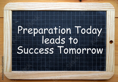 The phrase Preparation Today leads to Success Tomorrow in white text on a slate blackboard