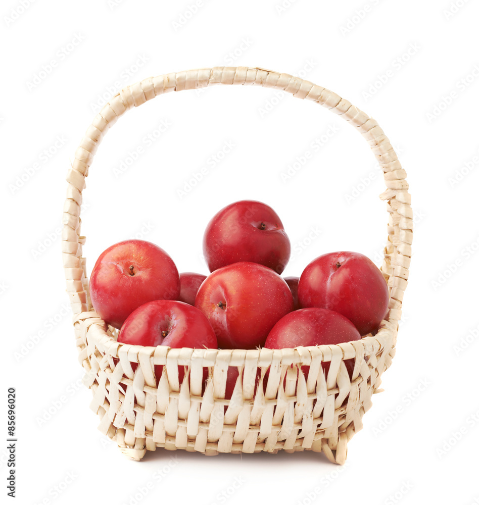 Wicker basked filled with plums Wicker basked filled with plums