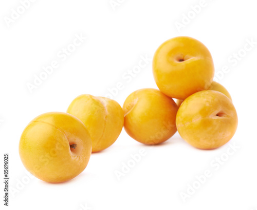 Pile of multiple yellow plums isolated