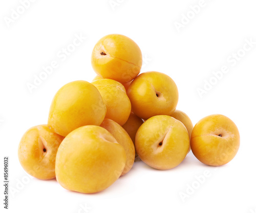 Pile of multiple yellow plums isolated