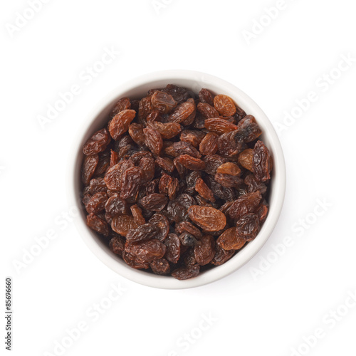 Cup filled with raisins isolated