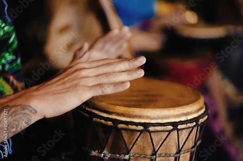 Man playing drum outdoors. African djemble