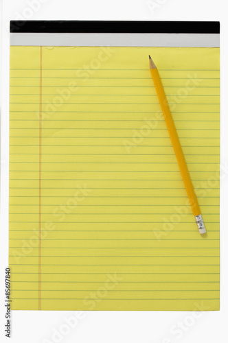 Yellow writing block with a pencil