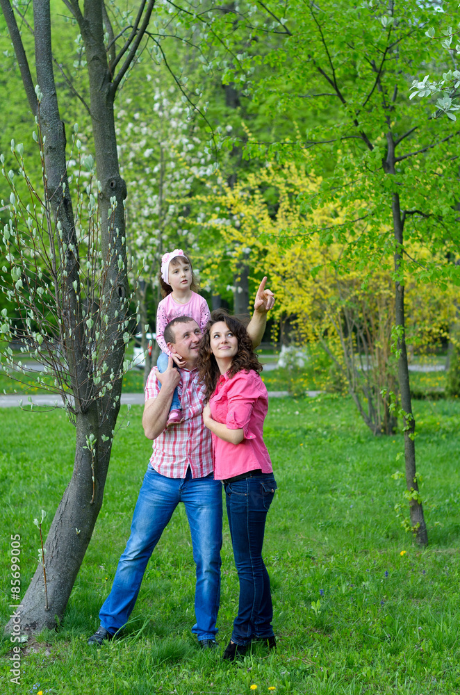 happy family plays a parka with a child