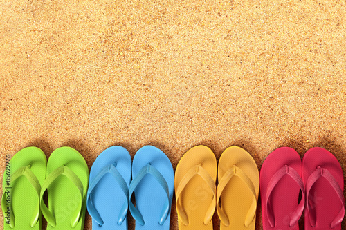 Row line border of flip flops flipflop summer beach sandals on a sand background team teamwork vacation holiday photo