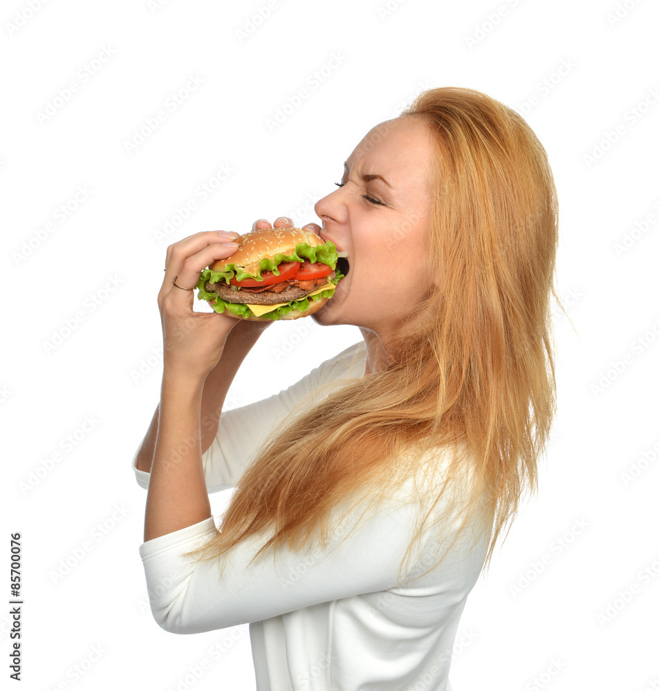 Fast food concept. Woman eating tasty unhealthy burger sandwich Fast food concept. Woman eating tasty unhealthy burger sandwich