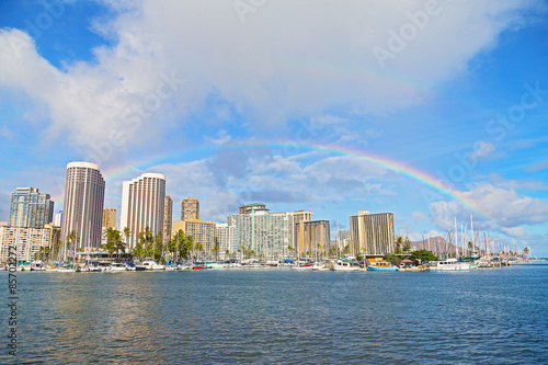 Rainbow over Waikiki beach resort and marina in Honolulu, Hawaii, USA. 
