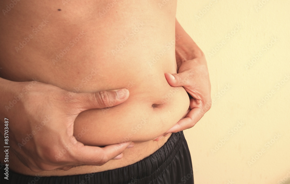 Man is holding his too fat tummy Man is holding his too fat tummy