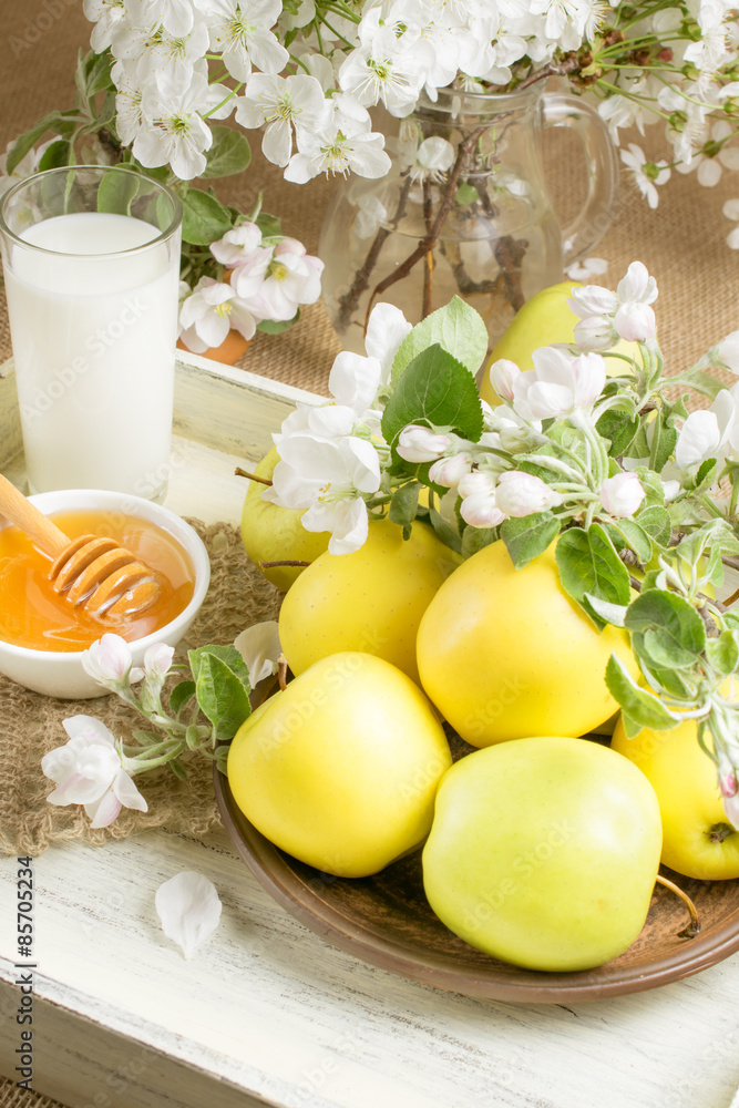 Still life with apples, twig of apple tree, milk and honey on th Still life with apples, twig of apple tree, milk and honey on th