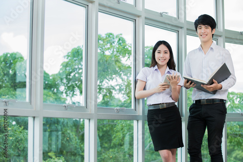 Asian student woman holding a tablet reading Free Download Asian student woman holding a tablet reading - GFXLoad