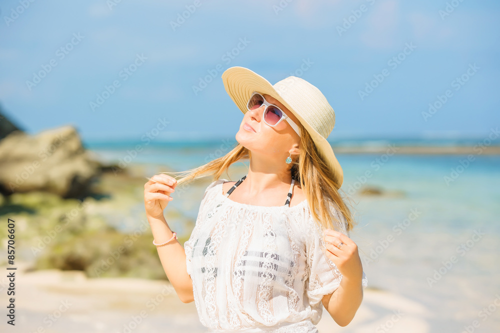 Colorful portrait of young pretty girl at the beach with blue
