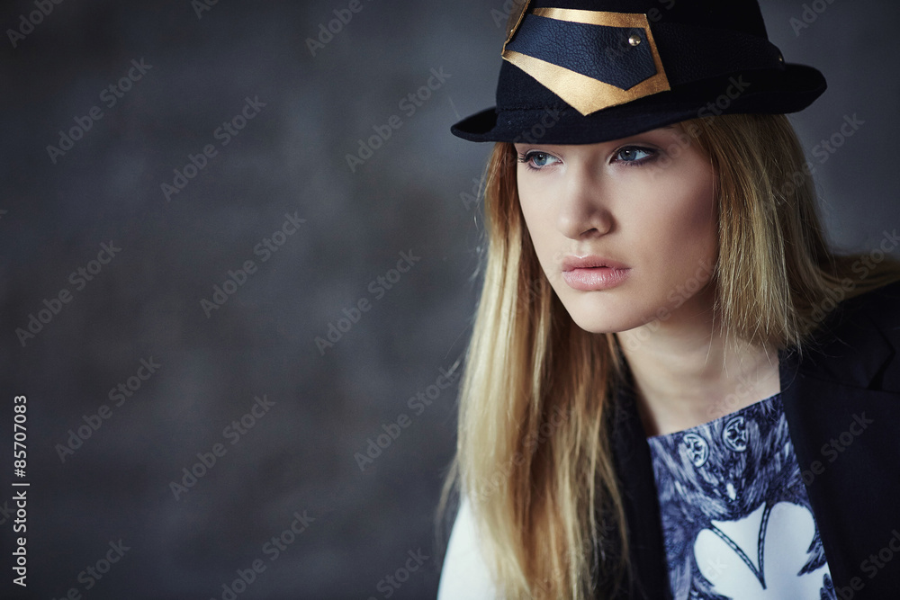Portrait of blond female in a hat. Portrait of blond female in a hat.