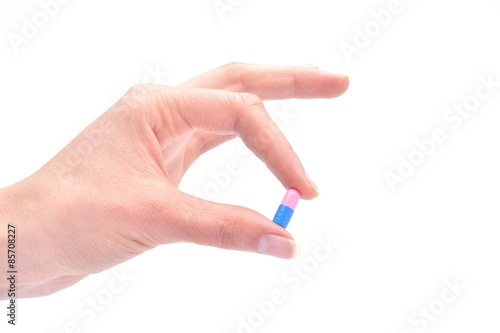 Close-up shot of a hand holding one pink pill