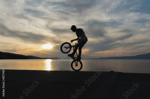 Biker jumping with the sunset as background.  