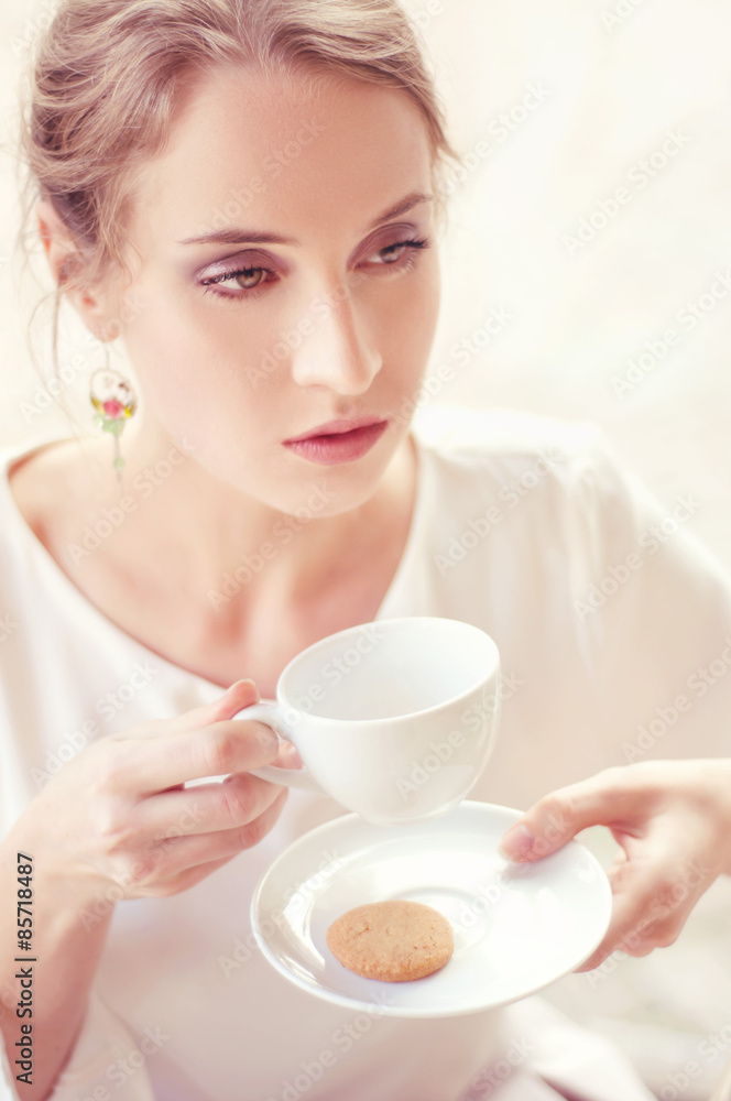 Beautiful elegant blonde sitting in a cafe drinking tea Beautiful elegant blonde sitting in a cafe drinking tea