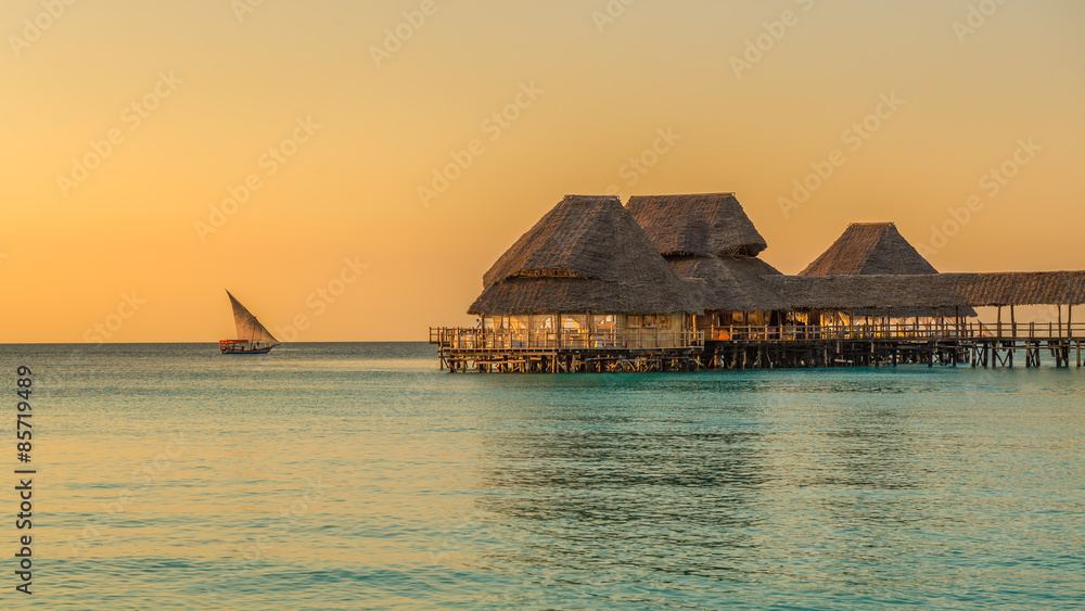 Fototapeta premium Bar and cafe on water at sunset in Zanzibar, Tanzania