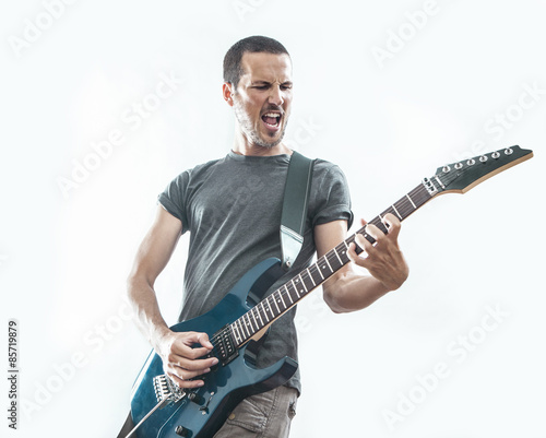 handsome young man playing electric guitar