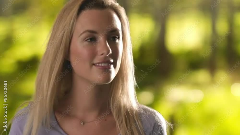 Glamorous woman walking through a park. Glamorous woman walking through a park.