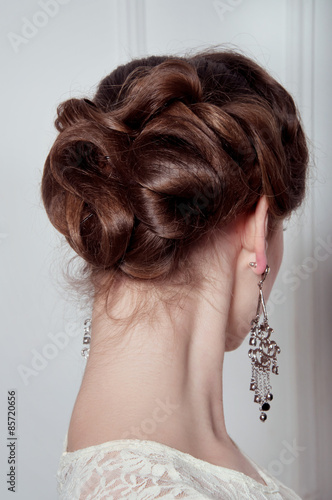 Studio portrait of elegant woman with evening hairdo
