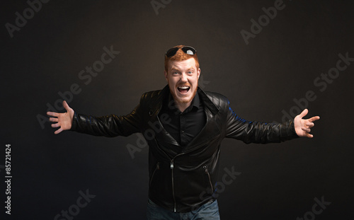 Angry red-haired man on a dark background
