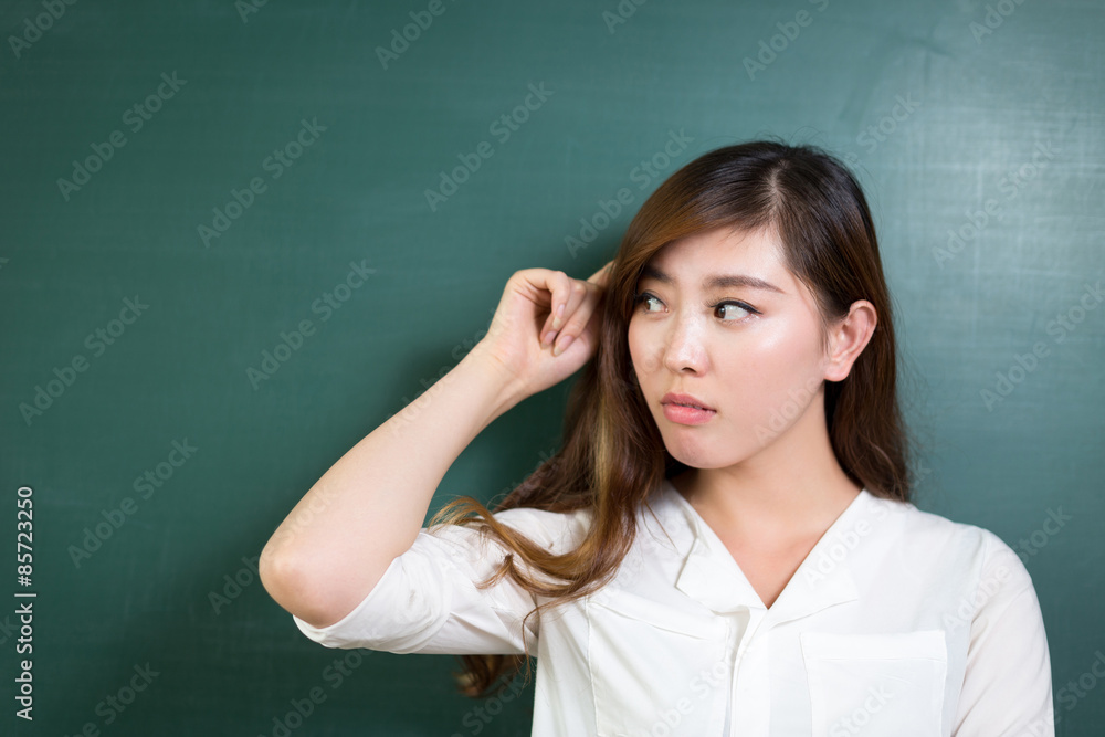 asian beautiful woman thinking in front of blackboard asian beautiful woman thinking in front of blackboard