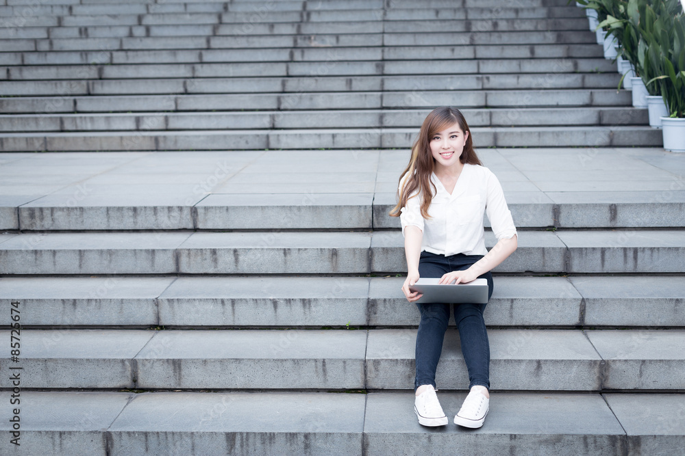 Asian female student using tablet in campus Asian female student using tablet in campus
