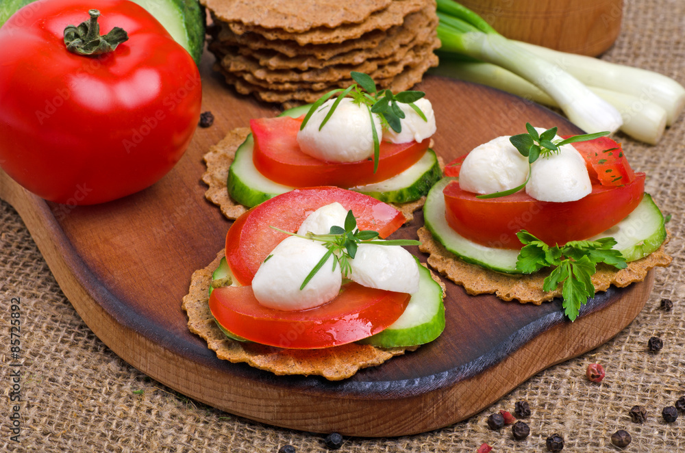 Caprese sandwiches of mozzarella cheese, tomatoes, cucumber and