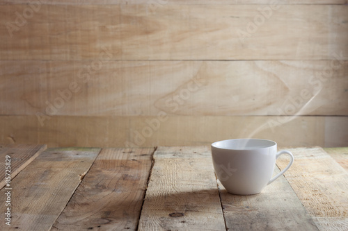 cup of coffee over wood background
